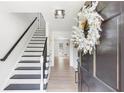 Inviting foyer with a staircase and light wood flooring, showcasing a modern aesthetic at 3794 Brown Owl Ct, Marietta, GA 30062