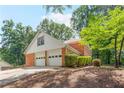 Side view of home showcasing a two-car garage and brick exterior at 3794 Brown Owl Ct, Marietta, GA 30062