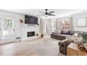 Bright living room with a white painted brick fireplace and hardwood floors at 3794 Brown Owl Ct, Marietta, GA 30062