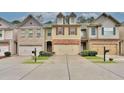 Townhome exteriors with coordinated design elements and convenient parking at 2626 Sardis Chase Ct, Buford, GA 30519
