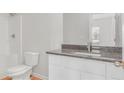 Bathroom featuring a granite countertop vanity and tiled shower at 271 Orwell Dr, Social Circle, GA 30025