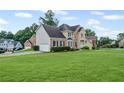 Beautiful two-story home with a spacious front yard and attached two-car garage at 479 Rising Sun Path, Lawrenceville, GA 30043