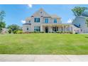 Charming two-story brick home with a manicured lawn and inviting front porch and an attached garage at 774 Phil Haven Ln, Kennesaw, GA 30152