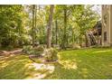Lush green backyard with mature trees and tiered deck at 840 Milton Oaks Dr, Johns Creek, GA 30022