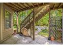 Covered patio featuring an outdoor staircase leading to backyard area with a pool at 840 Milton Oaks Dr, Johns Creek, GA 30022