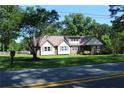 Inviting residence with a well-kept lawn, accented by mature trees and a durable metal roof at 5225 Kings Hwy, Douglasville, GA 30135