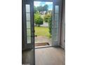View from entryway to front yard, visible through glass-paned front doors at 3219 Roundfield Cir, Duluth, GA 30096