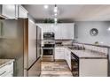 Modern kitchen featuring stainless steel appliances, white cabinets, and a stylish tile backsplash at 7750 Carnegie Dr, Fairburn, GA 30213