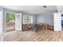 Bright living room with new wood-look floors and open view of the front yard at 3927 Buck Rd, Powder Springs, GA 30127