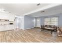 Spacious living room featuring wood-look flooring, open to kitchen and front entry at 3927 Buck Rd, Powder Springs, GA 30127