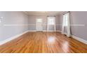 Open living room with hardwood floors, neutral paint, and a view of the front yard at 83 Ormond Se St, Atlanta, GA 30315