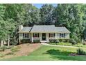 Inviting home with a covered porch, manicured bushes and beautiful lawn at 1990 Holly Cove Rd, Cumming, GA 30040
