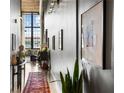 Hallway view featuring stylish decor, a vibrant rug, and natural light, creating a welcoming atmosphere at 170 Boulevard Se # 221E, Atlanta, GA 30312