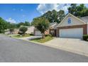 Street view of townhomes with attached garages, manicured lawns and mature trees at 2521 Eden Ridge Ln # 7, Acworth, GA 30101