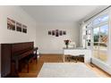 Sunlit office with large windows, hardwood floors, and a classic piano at 6040 Boulder Bluff Dr, Cumming, GA 30040