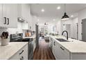 Modern kitchen with white cabinets, marble countertops, and stainless steel appliances at 12 Becker Nw Pl, Atlanta, GA 30307