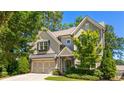 Charming two-story home with a well-manicured lawn, two-car garage, neutral siding, and black shutters at 1270 Briarwood Ne Rd, Atlanta, GA 30319