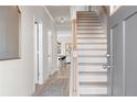 Bright entryway with hardwood floors, a staircase, and neutral paint at 209 Chiswick Loop, Stockbridge, GA 30281