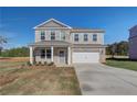 Two-story home with a manicured lawn, two car garage, and beautiful stone and brickwork at 209 Chiswick Loop, Stockbridge, GA 30281