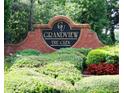 Grandview The Glen community sign surrounded by lush landscaping and colorful plants at 5157 Wellisford Ct, Suwanee, GA 30024
