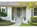 Inviting front entrance with stone steps, gray door with sidelights, and meticulously maintained landscaping at 1956 Regents Way, Marietta, GA 30062