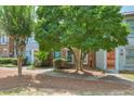 Charming townhome exteriors with sidewalks, mature trees, and inviting colorful front doors at 4177 Elder Ln, Duluth, GA 30096