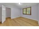 Bright bedroom with hardwood floors, a window, and a closet for ample storage space at 849 N Park Ave, Marietta, GA 30060