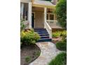Inviting front porch with stone walkway, blue stairs, and white railings, perfect for relaxing at 2732 Arbor Se Ave, Atlanta, GA 30317