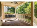 Relaxing covered porch with ceiling fan and comfortable swing, ideal for enjoying the outdoors at 2732 Arbor Se Ave, Atlanta, GA 30317