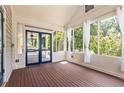Bright screened porch with wood floors and plenty of natural light with access to the rear of the property at 2732 Arbor Se Ave, Atlanta, GA 30317