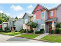 Street view of townhouses showcasing colorful exteriors, landscaped yards, and sidewalks at 4206 Mastic Pt # 24, Acworth, GA 30101