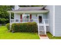 Inviting front porch with white railing, partial seating and an entrance into the home at 1876 Kathy Ct, Douglasville, GA 30135