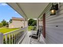 Charming front porch featuring white railing, comfortable seating, and a view of the front yard at 1876 Kathy Ct, Douglasville, GA 30135