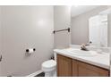Simple and clean half bath with a white toilet, wooden vanity, and a mirror, offering functionality at 2917 Duncan Pl, Decatur, GA 30034