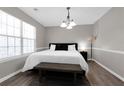 Inviting bedroom with a large window, queen-sized bed, hardwood floors, and stylish modern decor at 2917 Duncan Pl, Decatur, GA 30034