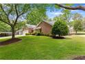 Brick home with green lawn, mature trees, and side entry garage at 3690 Lithia Way, Lithia Springs, GA 30122