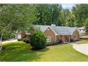 Brick home boasts a lush green lawn and well-maintained landscaping, showcasing its curb appeal at 3690 Lithia Way, Lithia Springs, GA 30122