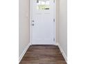 Inviting entryway features a white front door, dark wood-look flooring, and neutral walls at 4095 Indian Creek Cir, Stone Mountain, GA 30083