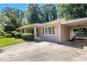 Stylish home featuring neutral paint, shutters, a covered carport, and a well-maintained driveway at 4095 Indian Creek Cir, Stone Mountain, GA 30083
