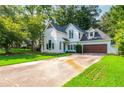 Beautiful two-story house featuring a well-kept lawn and a driveway at 5271 Oglethorpe Ct, Powder Springs, GA 30127
