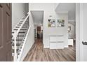 Inviting foyer with hardwood floors, staircase, neutral paint, and access to the kitchen at 1786 Jameson Cir, Lawrenceville, GA 30043