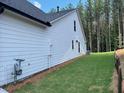Exterior shot showcasing the side yard of the house with lush greenery at 301 Brooke View Trail, Canton, GA 30115