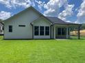 Exterior view showing an outdoor covered patio and backyard with vibrant green grass at 301 Brooke View Trail, Canton, GA 30115
