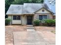 Traditional home exterior with a concrete driveway and walkway leading to the front entrance with green shrubbery at 1106 Shiloh Nw Ln, Kennesaw, GA 30144