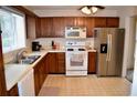 Functional kitchen with light countertops, appliances, wood cabinets, and bright natural light at 1106 Shiloh Nw Ln, Kennesaw, GA 30144