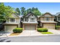 Inviting townhome exterior with neutral siding, brick accents, and lush green landscaping at 122 Creighton Ln, Marietta, GA 30008