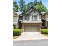 Attractive townhouse featuring brick accents, a two-car garage, and tidy landscaping at 122 Creighton Ln, Marietta, GA 30008