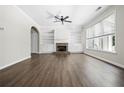 Bright living room with hardwood floors, a brick fireplace, and built-in bookshelves at 122 Creighton Ln, Marietta, GA 30008