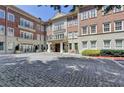Elegant brick building featuring stone accents, balconies, and a cobblestone drive at 5415 Northland Ne Dr # 303, Atlanta, GA 30342