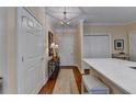 Hallway with hardwood floors, a decorative table, and white closets near the kitchen at 5415 Northland Ne Dr # 303, Atlanta, GA 30342